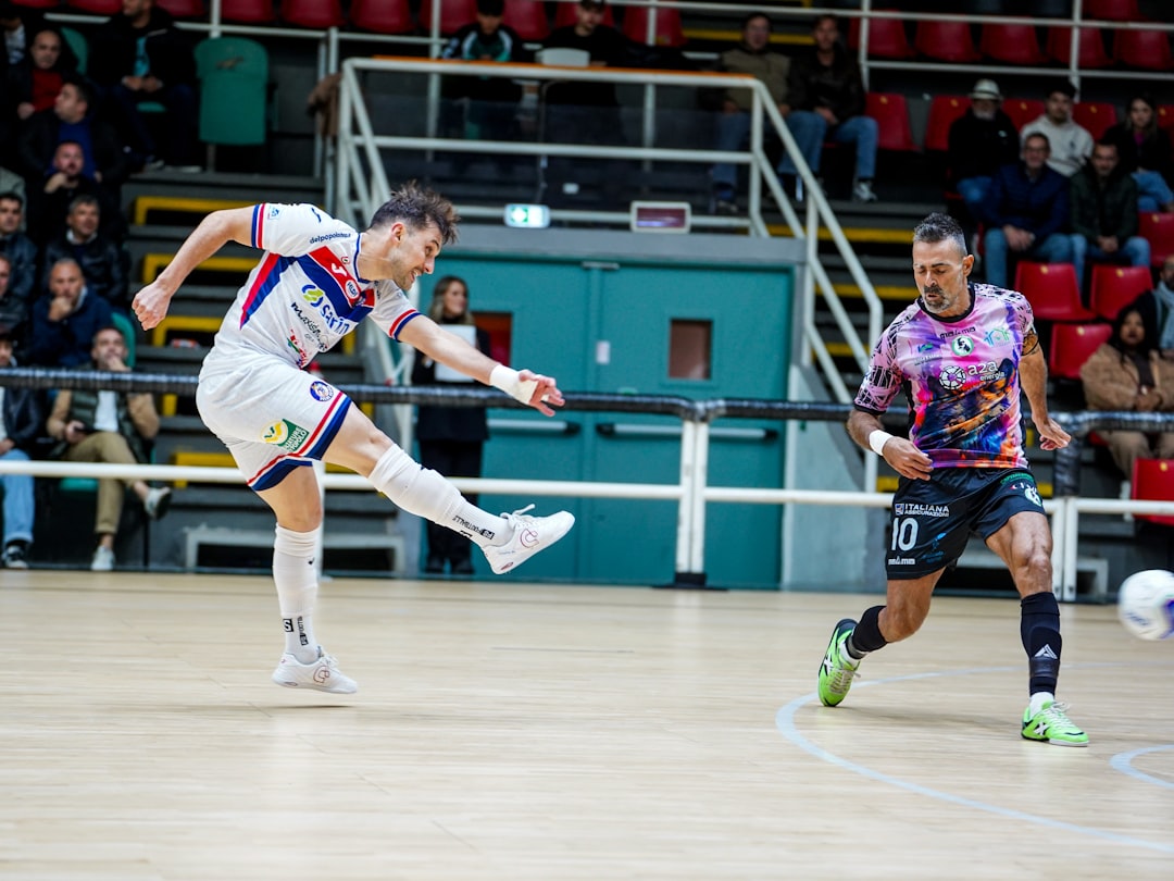 two-men-playing-futsal-indoors-on-a-wooden-court-9ckhccl3lum